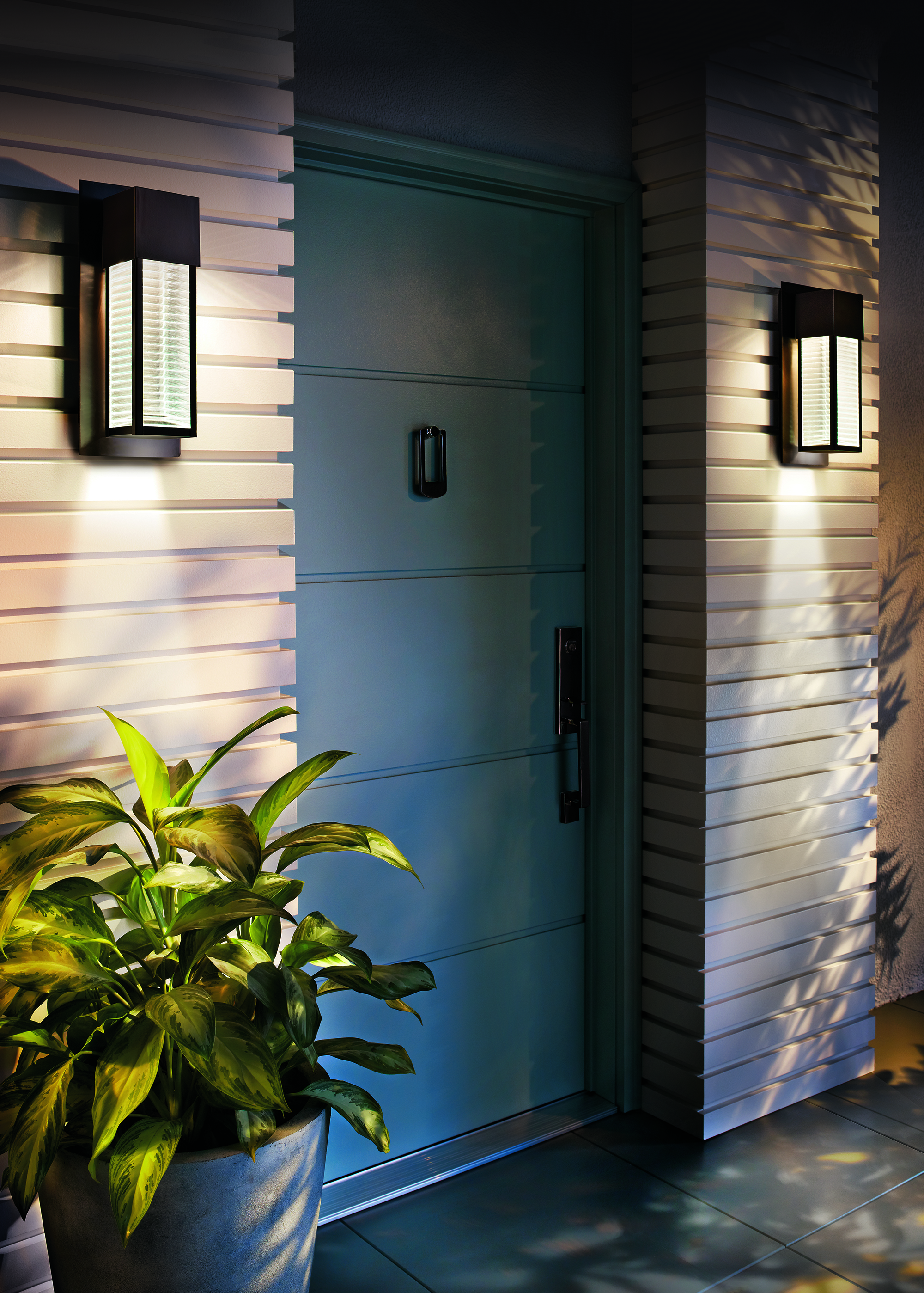 Two outdoor porch lights by blue door