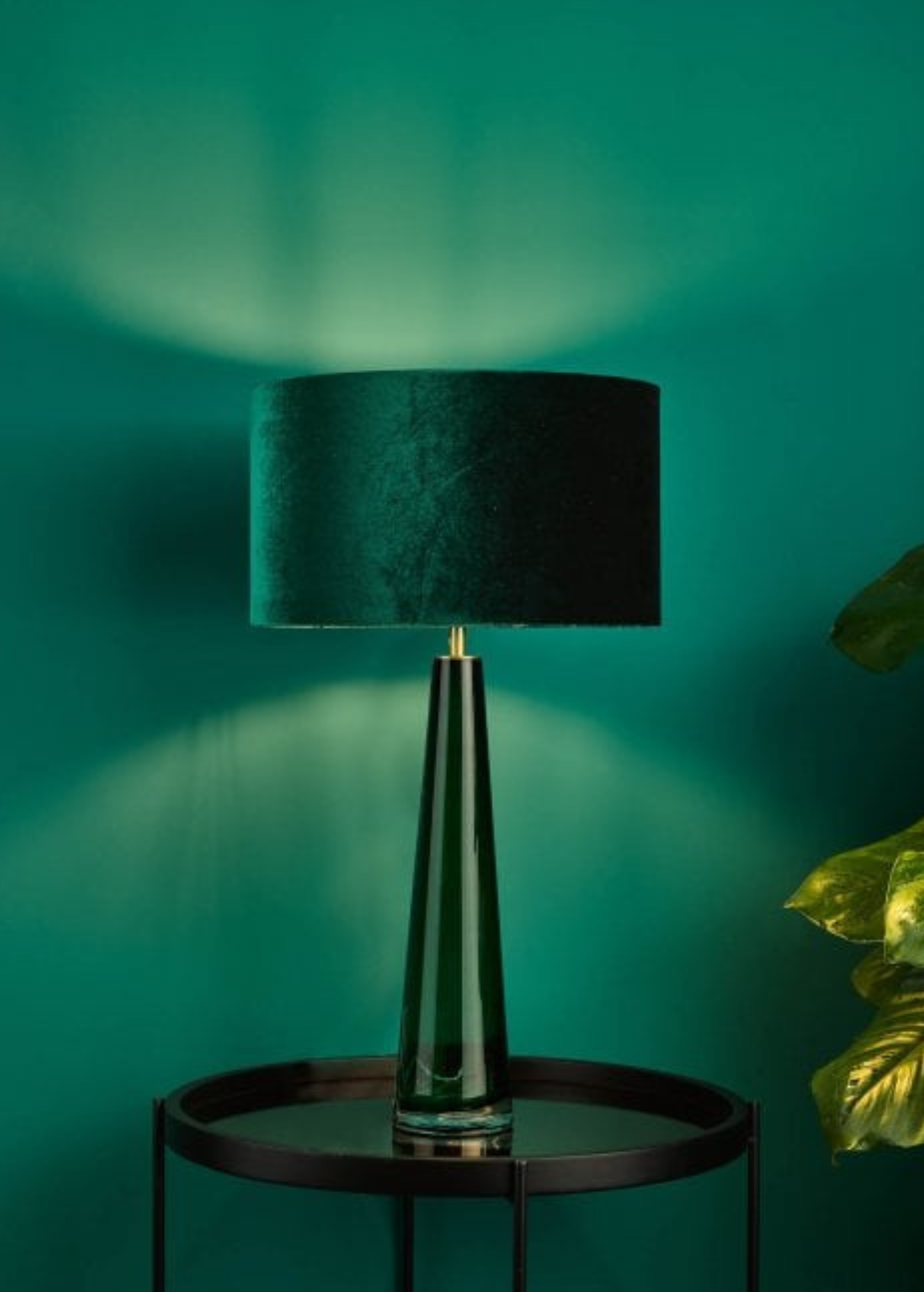 Green table lamp on glass table 