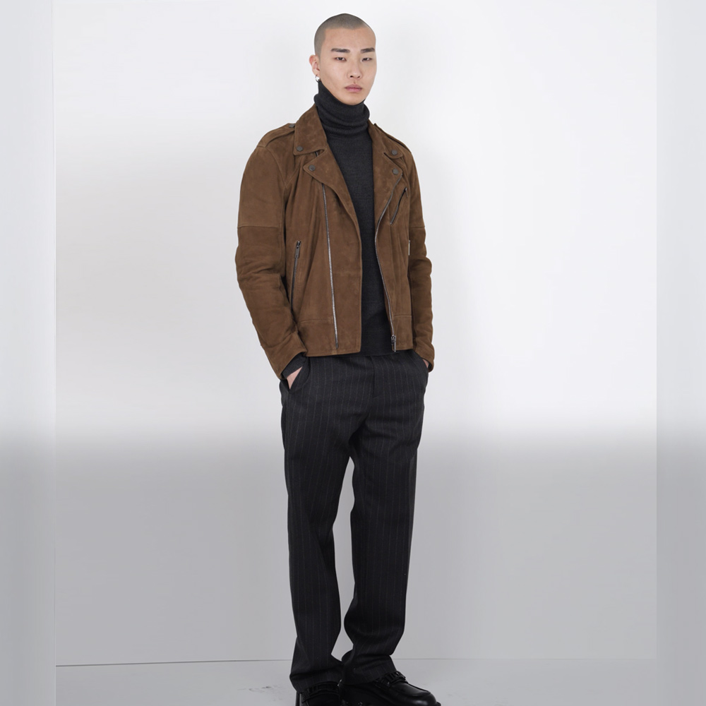 Man with black pinstripe pants and brown suede jacket