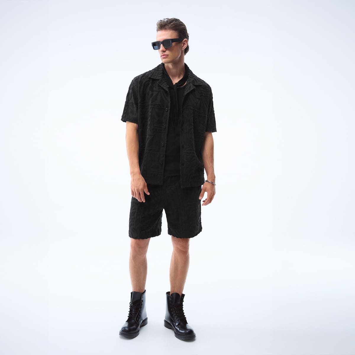 joop jeans man with black short sleeve shirt and black shorts