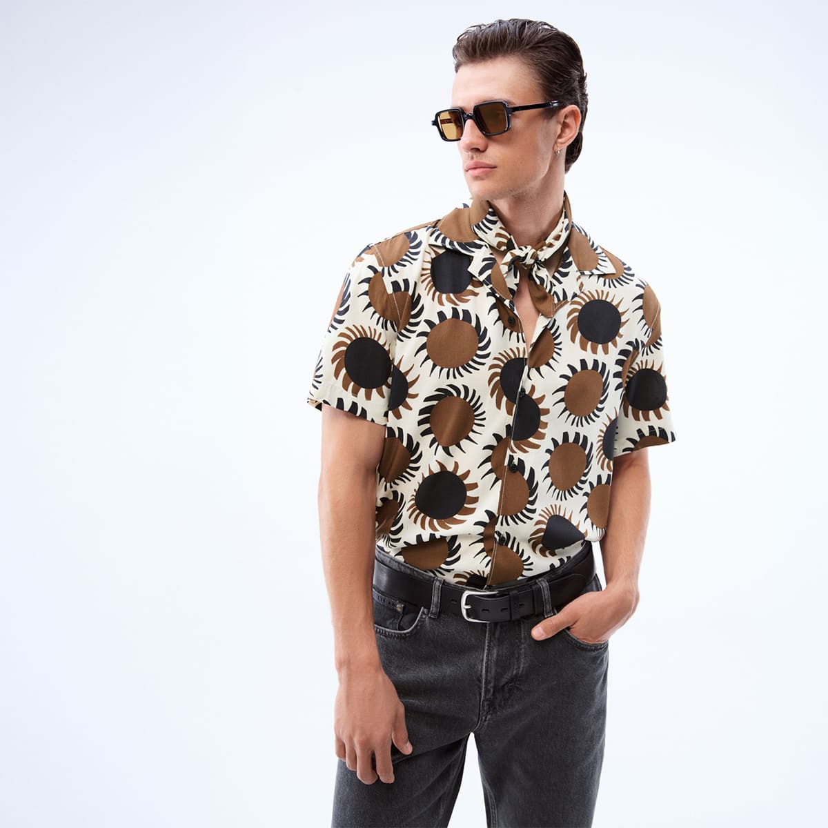 joop jeans man with brown, black, beige patterned shirt and black jeans