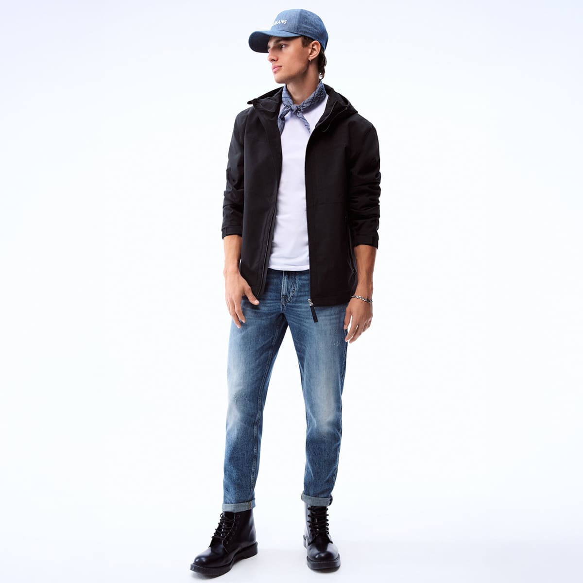 joop jeans mann mit blauer Cap, schwarzer Jacke, weissem Tshirt und blauer jeans