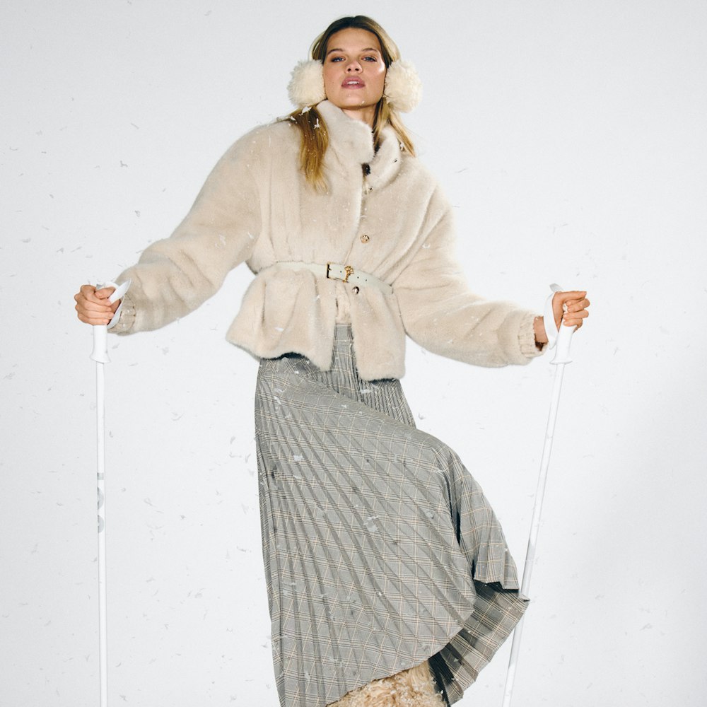 JOOP! Woman in cream quilted jacket with pleated skirt