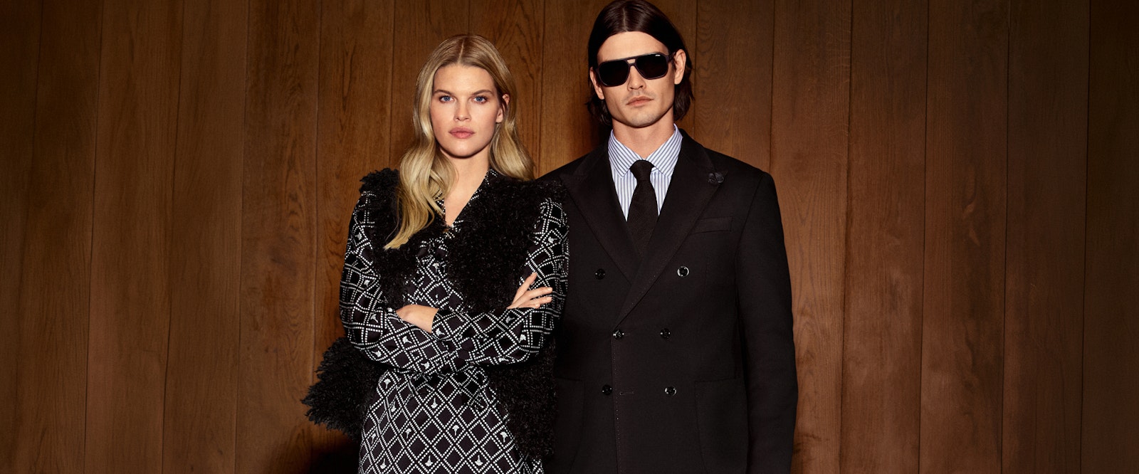 JOOP! Man in black double-breasted suit with sunglasses and woman in black-and-white patterned tweed jacket