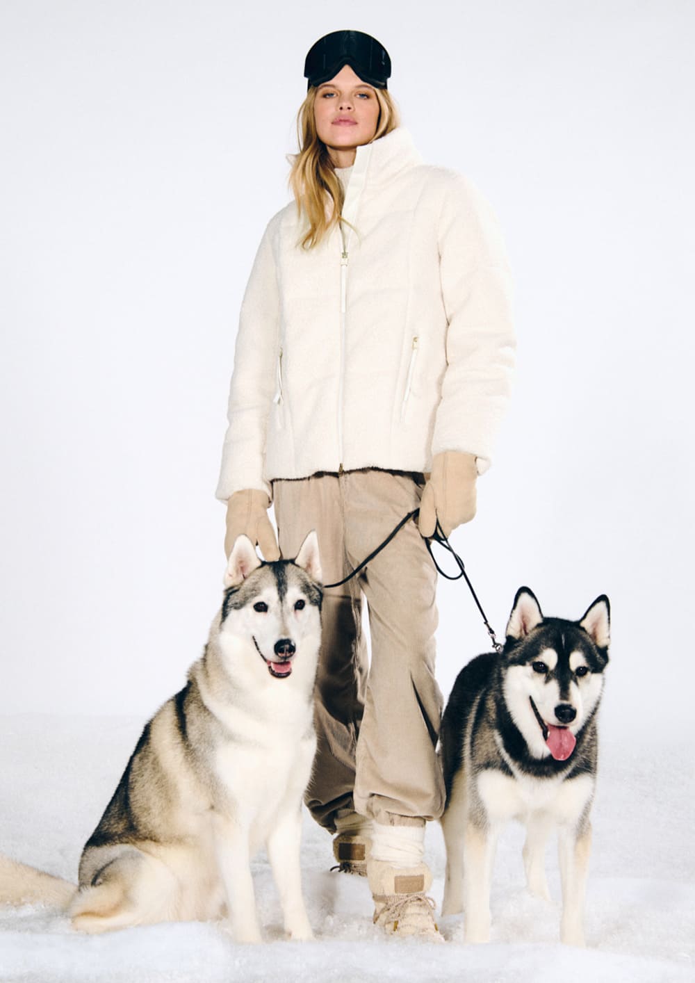 Woman wearing a cream-colored Joop teddy jacket with beige pants