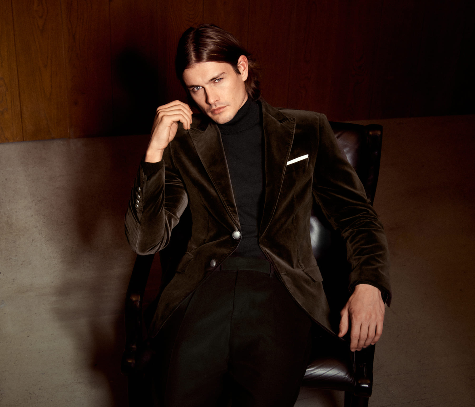 Joop, a man wearing a brown velvet blazer and a black turtleneck sweater