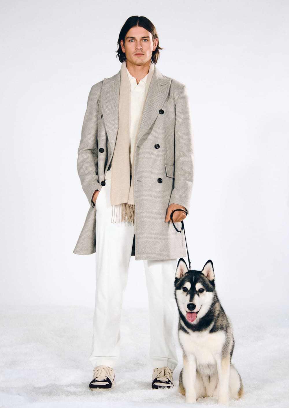 Joop, a man wearing a light gray double-breasted coat and light-colored pants