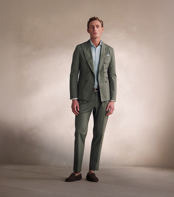 windsor Man in a light blue suit with a knitted garment in his hand